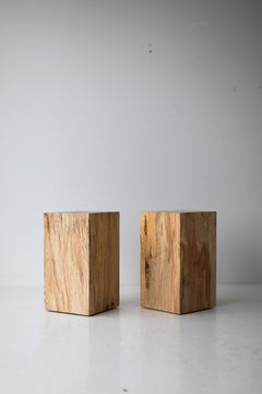 Maple stump used as a nightstand beside a bed