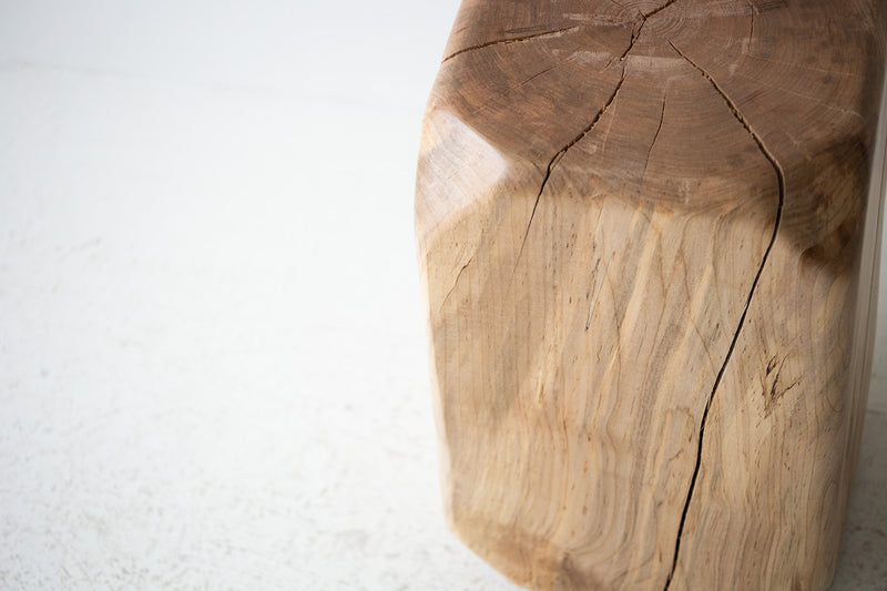 Pale maple stool photographed at an angle