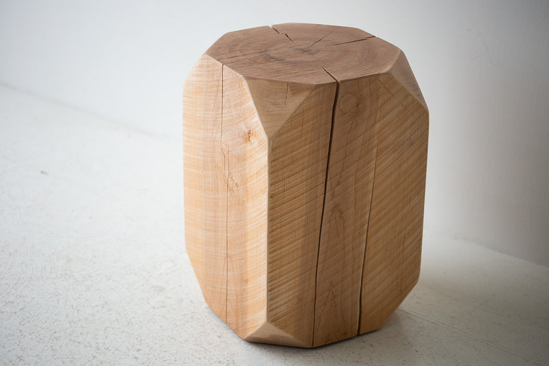Sculpted, angled corners of the maple stool