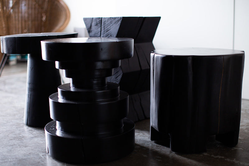 Tulum stool used as a side table next to a chair