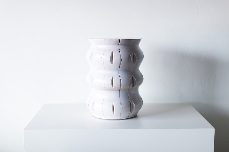 Organic modern side table styled in a bright interior