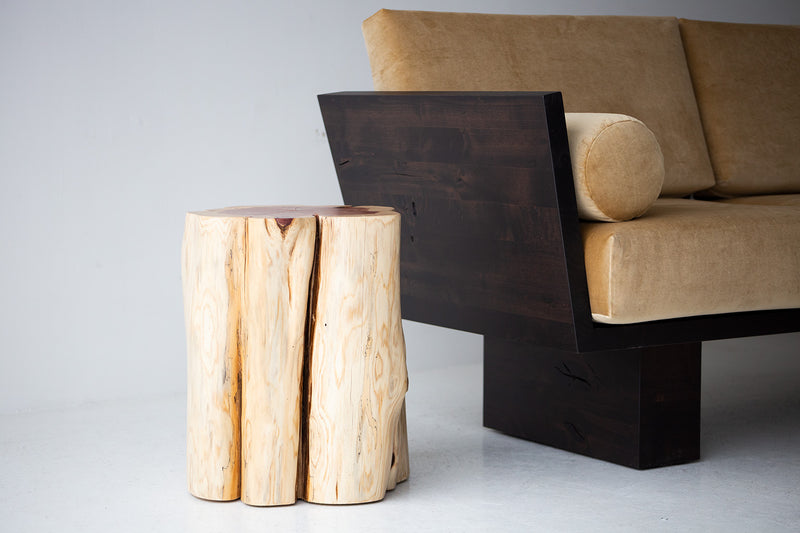 Natural red cedar stump end table at a three-quarter angle