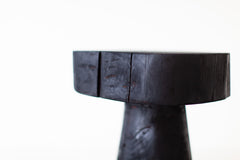 Modern luxury shou sugi ban side table styled next to a sofa
