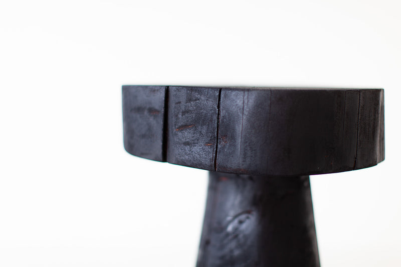Modern luxury shou sugi ban side table styled next to a sofa