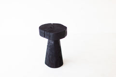 Modern shou sugi ban side table styled next to a bathtub