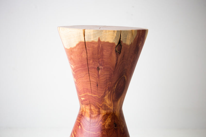 The Hourglass sculpted stump side table and nightstand shown at an angle