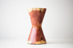 Close-up of the sculpted hourglass silhouette on the red cedar stump table
