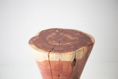 The Hourglass wood stump side table styled beside a modern sofa