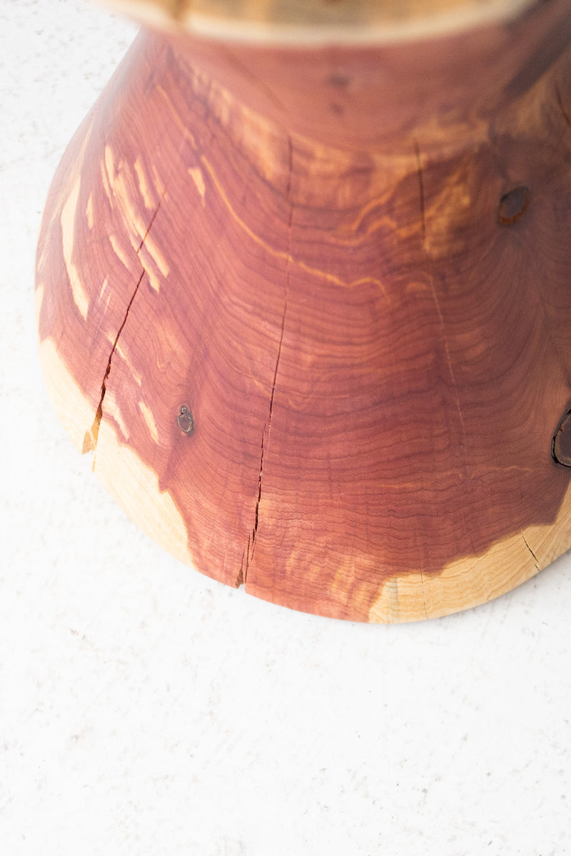 Side profile of The Hourglass waisted sculpted stump side table
