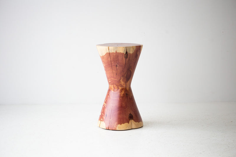 The Hourglass modern wood stump side table styled in an organic-modern living room