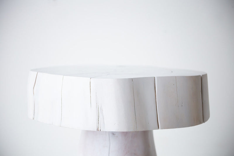 The Summit whitewash stump side table and nightstand shown at an angle