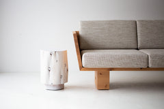 The Totem sculpted stump side table and nightstand shown at an angle
