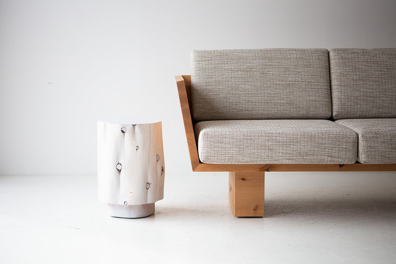 The Totem sculpted stump side table and nightstand shown at an angle