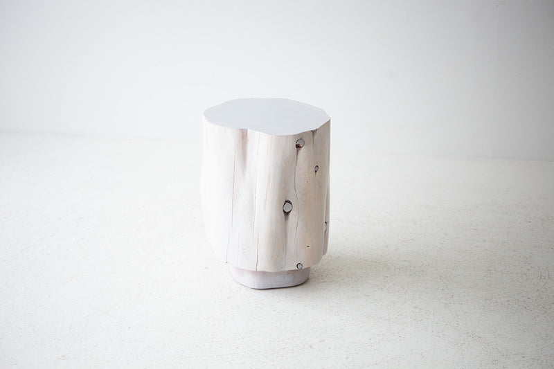Close-up of the tall totem silhouette on the red cedar stump table