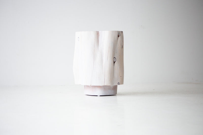 The Totem modern wood stump side table styled in an organic-modern living room