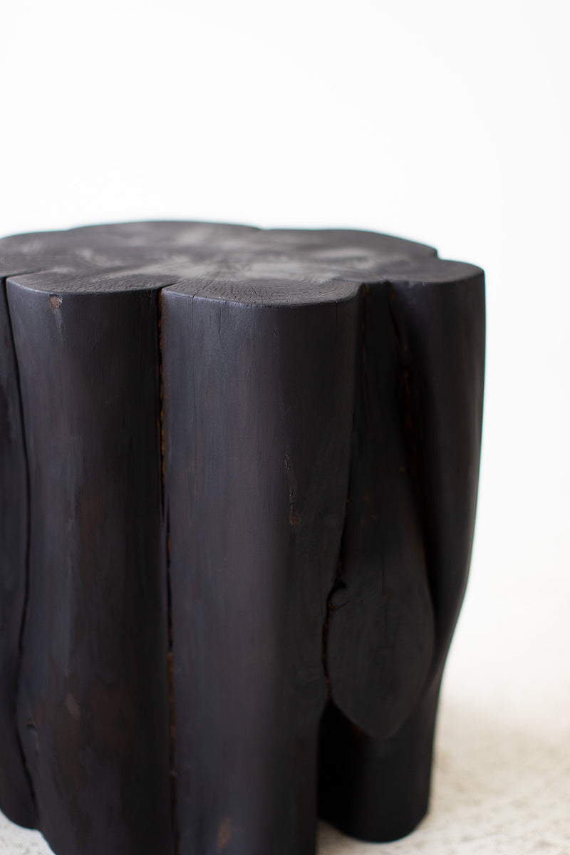 Bertu Home charred stump table shown at an angle