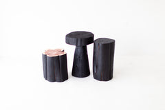 Modern luxury shou sugi ban stump table styled in a living room