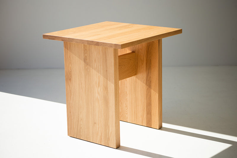 White oak game table styled in a bright interior
