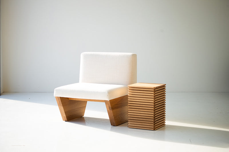 White oak side table used as a nightstand
