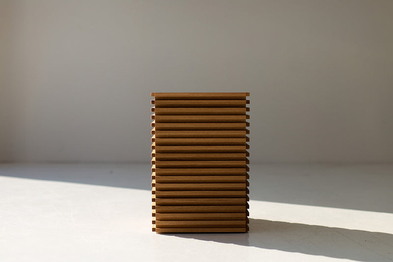 Organic modern white oak side table in a bright interior