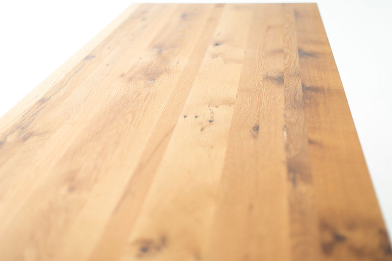 Close-up of the tabletop edge on the modern luxury oak farmhouse table