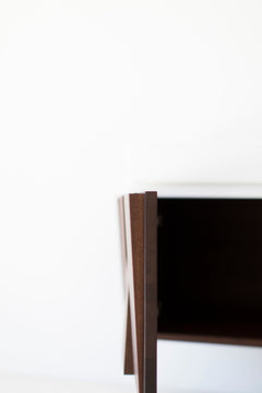 Floating nightstand styled in a mid-century bedroom setting