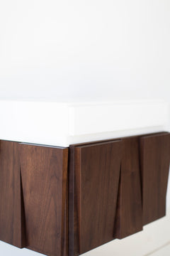 Angled view of the Craft Associates floating walnut nightstand