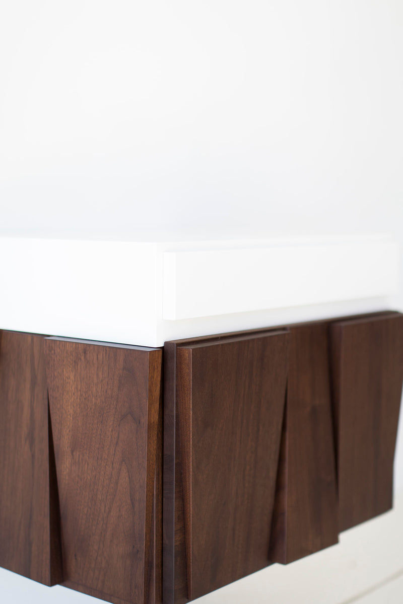 Angled view of the Craft Associates floating walnut nightstand