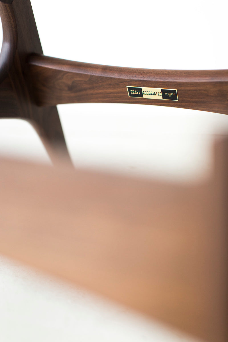 Detail of the walnut wood grain on the Peabody chair frame