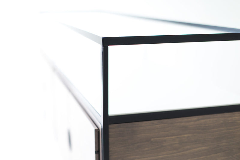 Close-up of the powder-coated steel legs on the modern luxury credenza