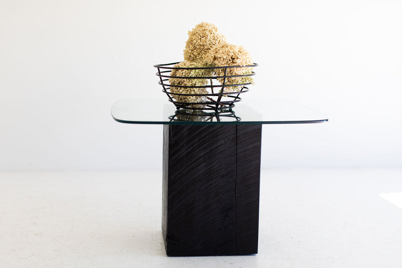 Modern luxury glass-top coffee table with maple stump base by Bertu Home, front view