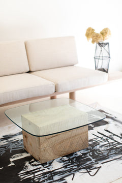 Modern luxury glass-top coffee table styled in a living room