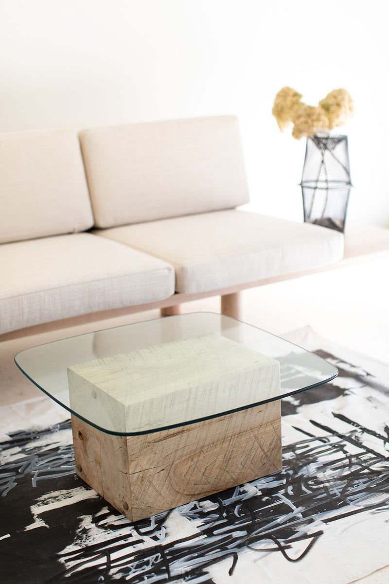 Modern luxury glass-top coffee table styled in a living room