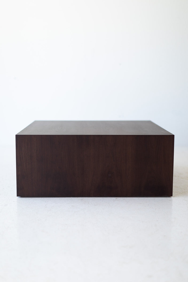 Modern luxury walnut coffee table shown from a low angle