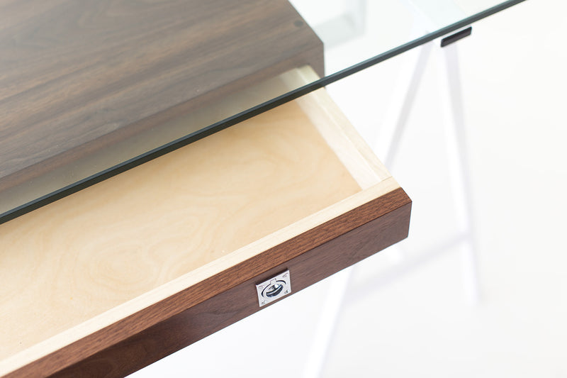 Modern luxury walnut and glass desk styled in a home office