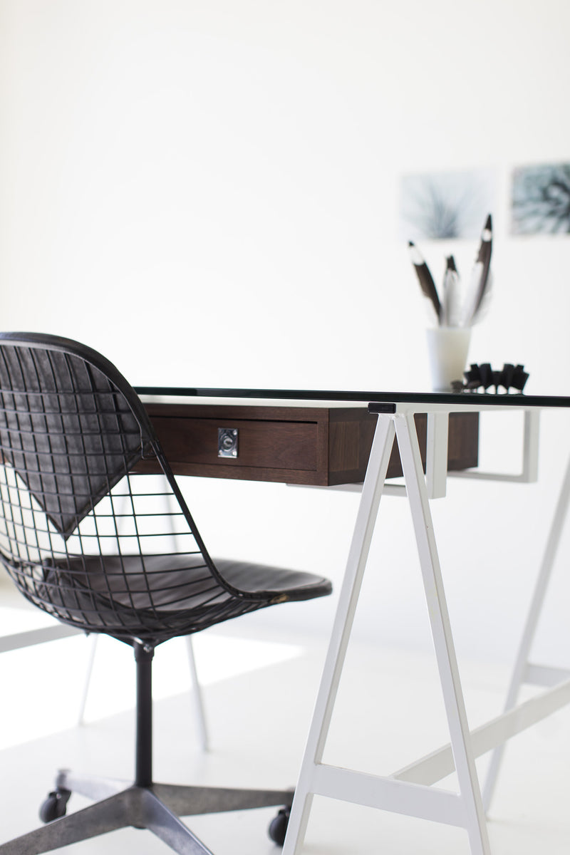 Detail of the glass top and oiled walnut frame on the modern luxury desk