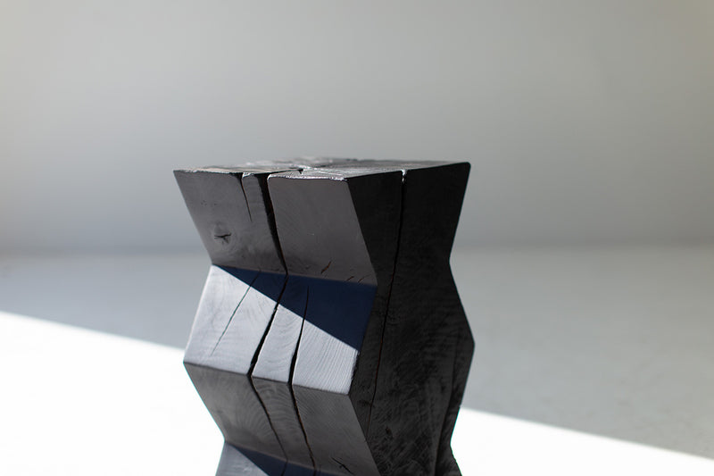 Bertu Home burnt finish stump table shown at an angle